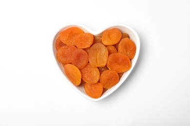 Photo of Bowl with dried apricots on white background, top view. Healthy fruit