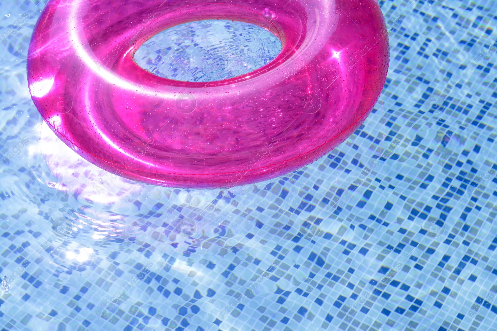 Photo of Inflatable ring floating on water in swimming pool