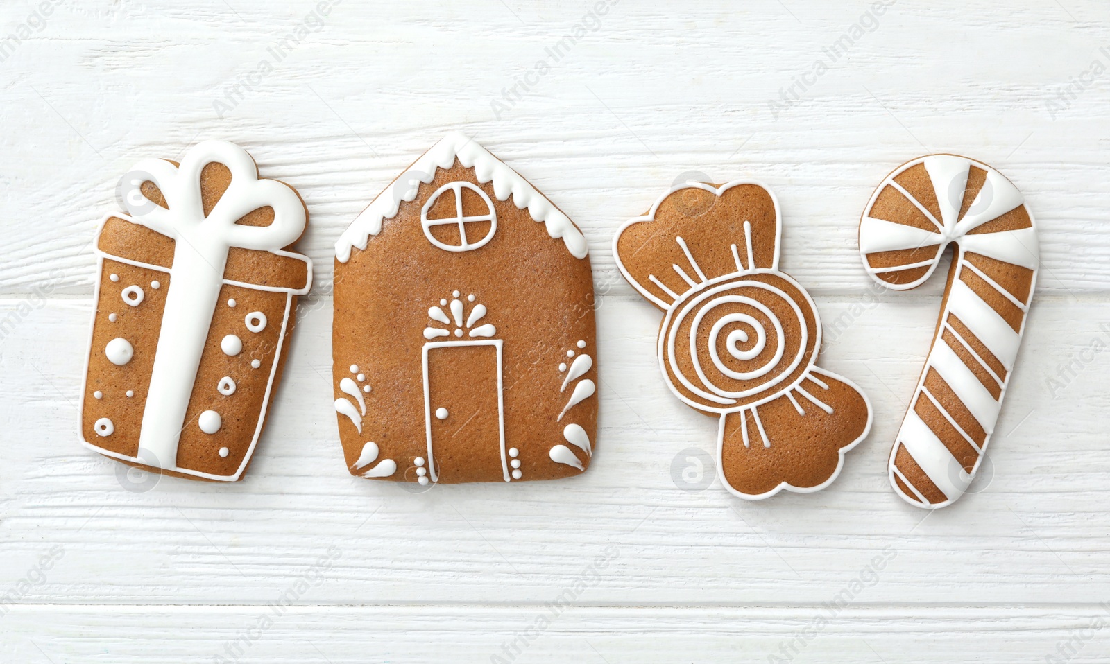 Photo of Different delicious Christmas cookies on white wooden table, flat lay