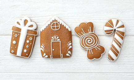 Photo of Different delicious Christmas cookies on white wooden table, flat lay