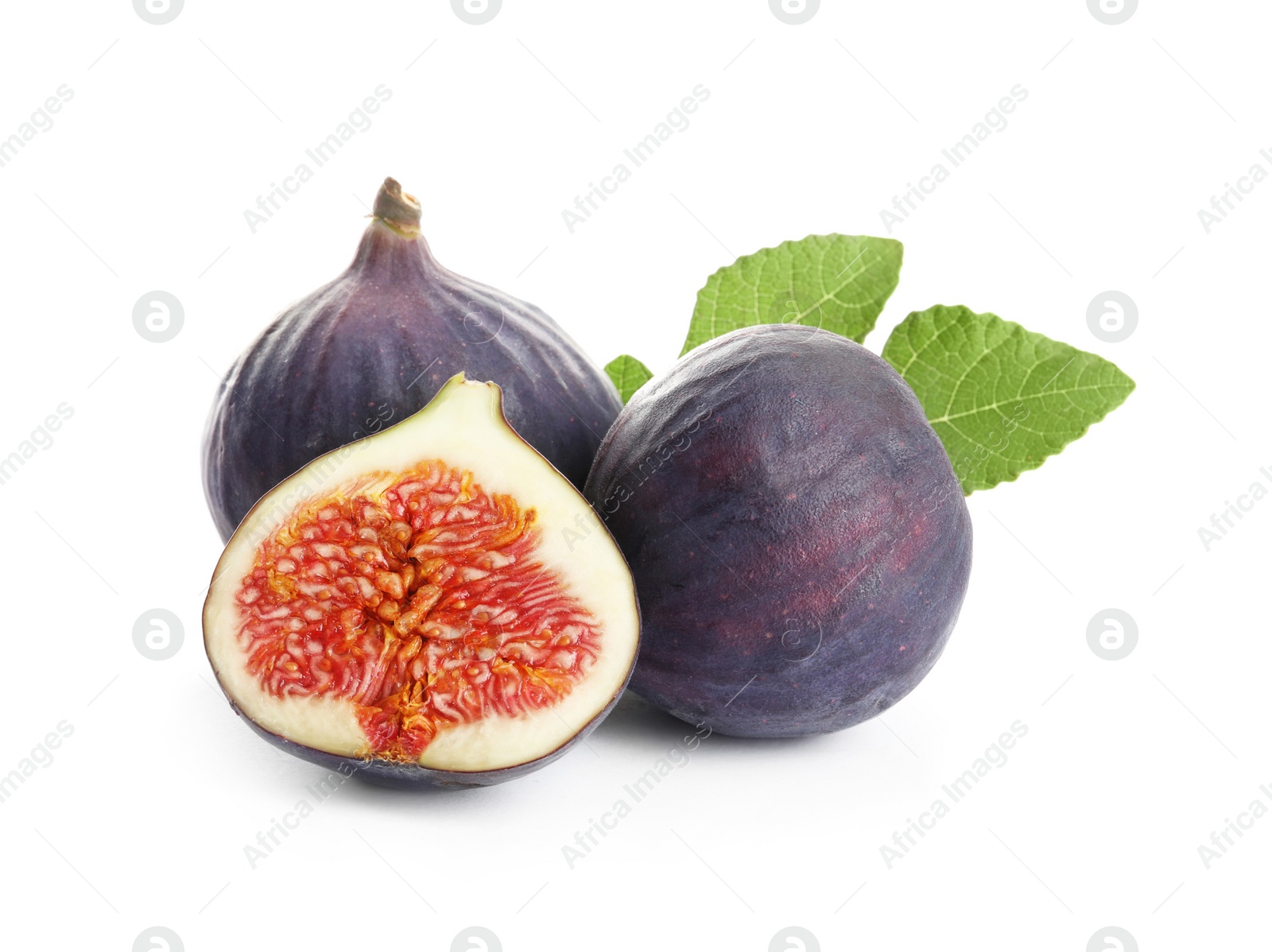 Photo of Whole and cut purple figs on white background