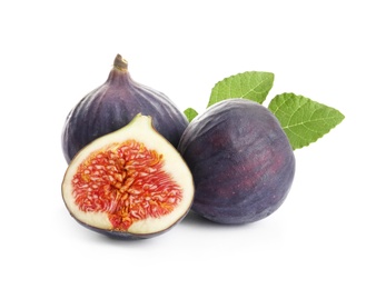 Whole and cut purple figs on white background