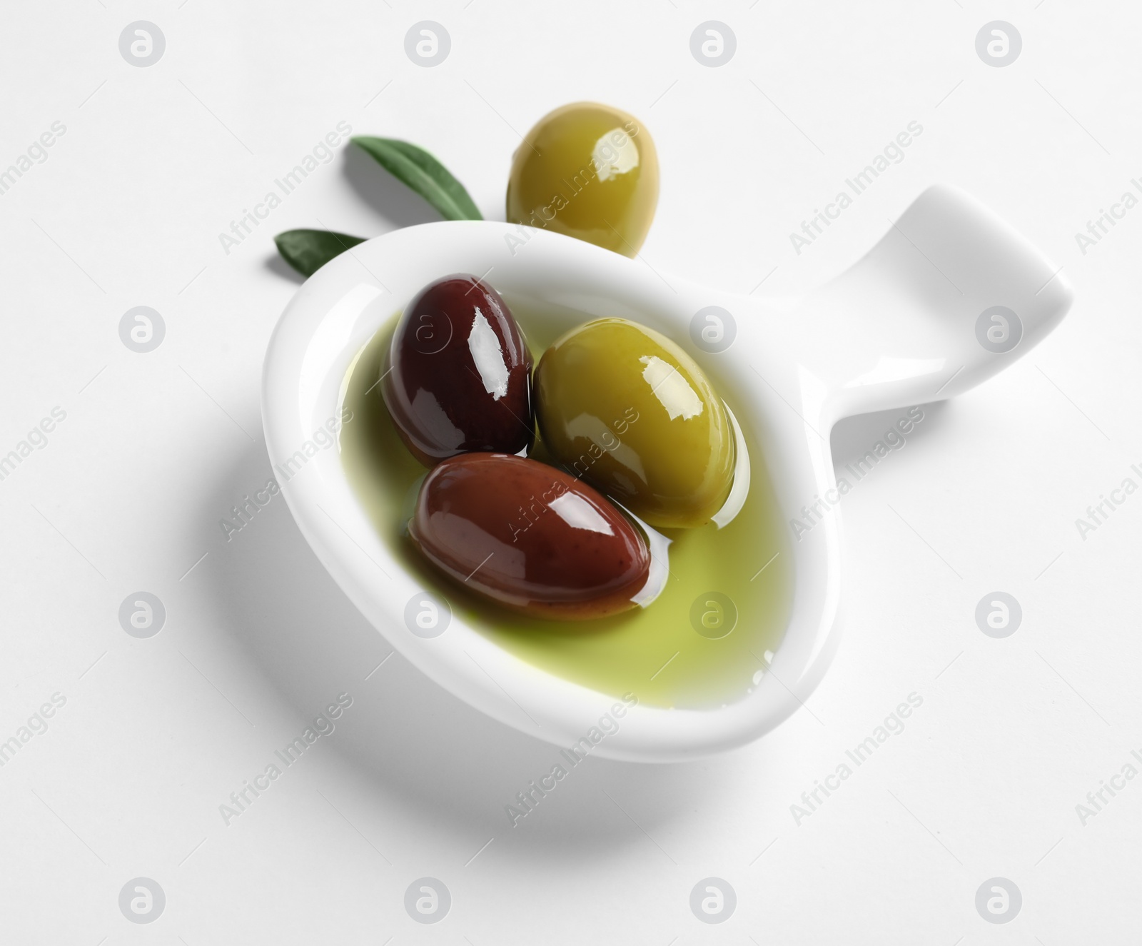 Photo of Bowl with fresh olives in oil on white background