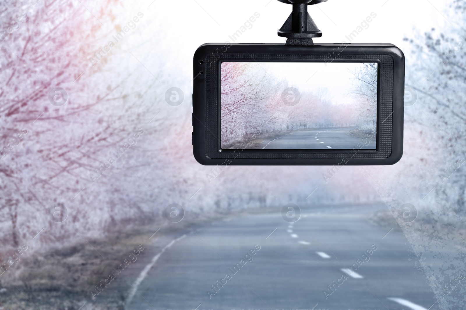 Image of Modern dashboard camera mounted in car, view of road during driving