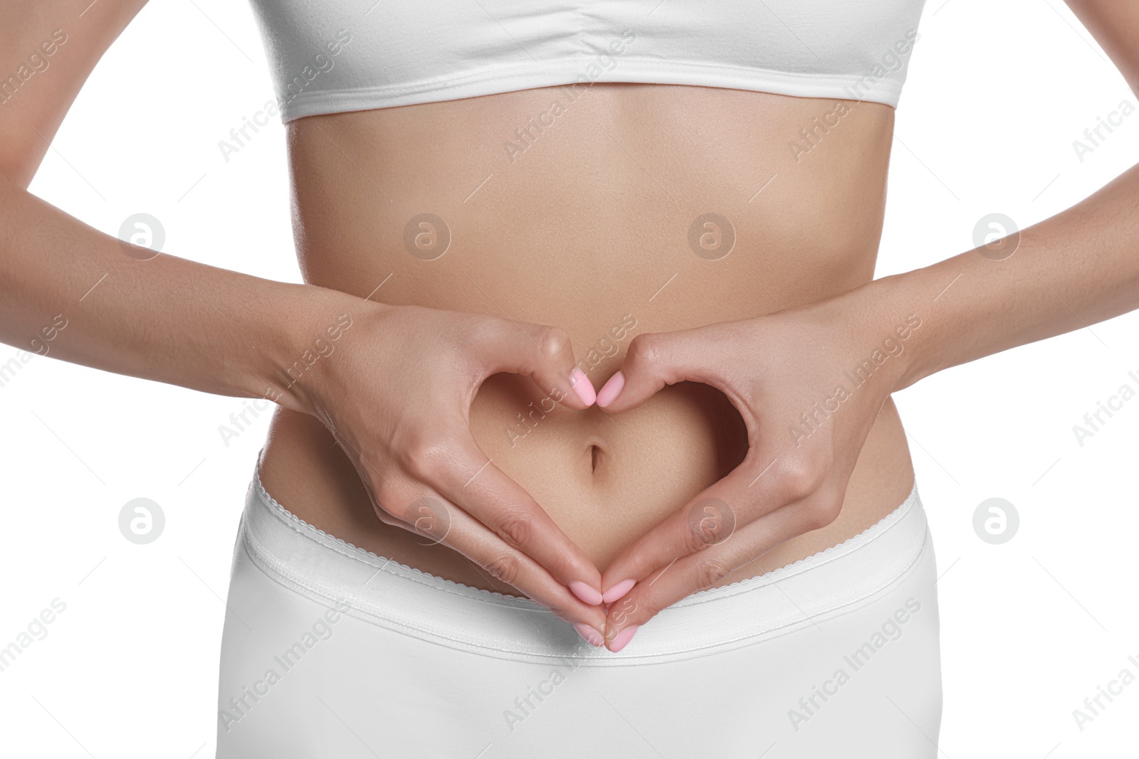 Photo of Woman in underwear making heart with hands on her belly near white background, closeup. Healthy stomach