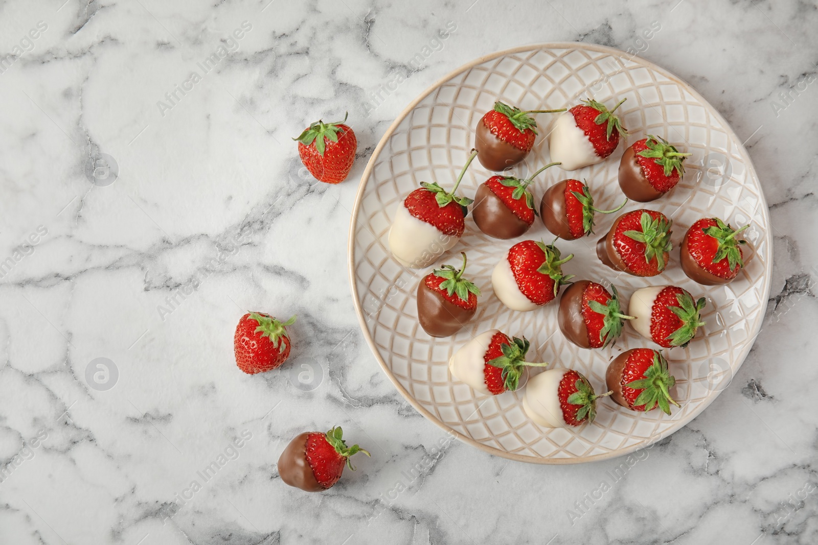 Photo of Flat lay composition with chocolate covered strawberries on marble background