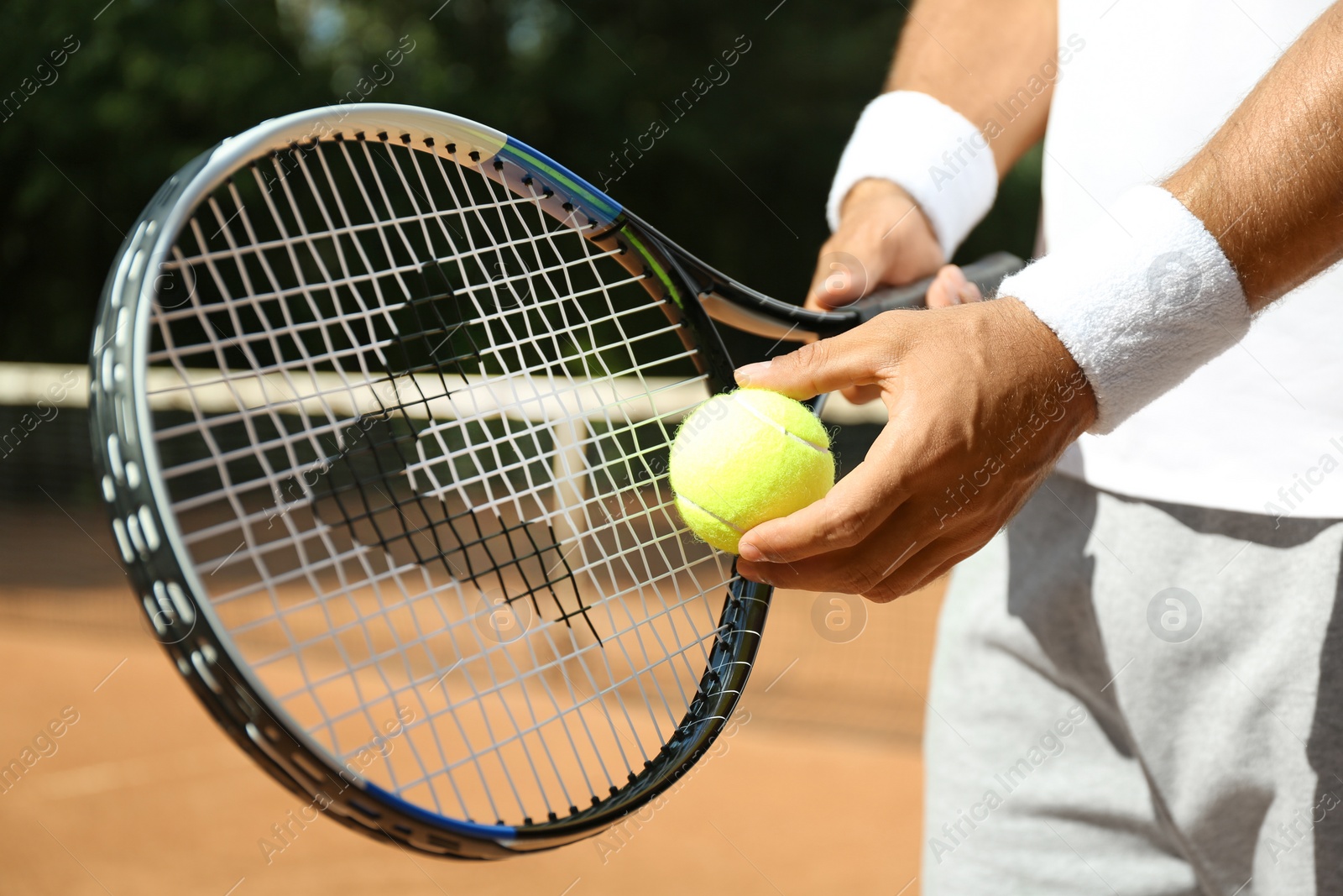 Photo of Sportsman preparing to serve tennis ball at court, closeup