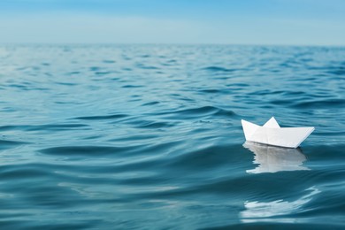 White paper boat floating on river, space for text