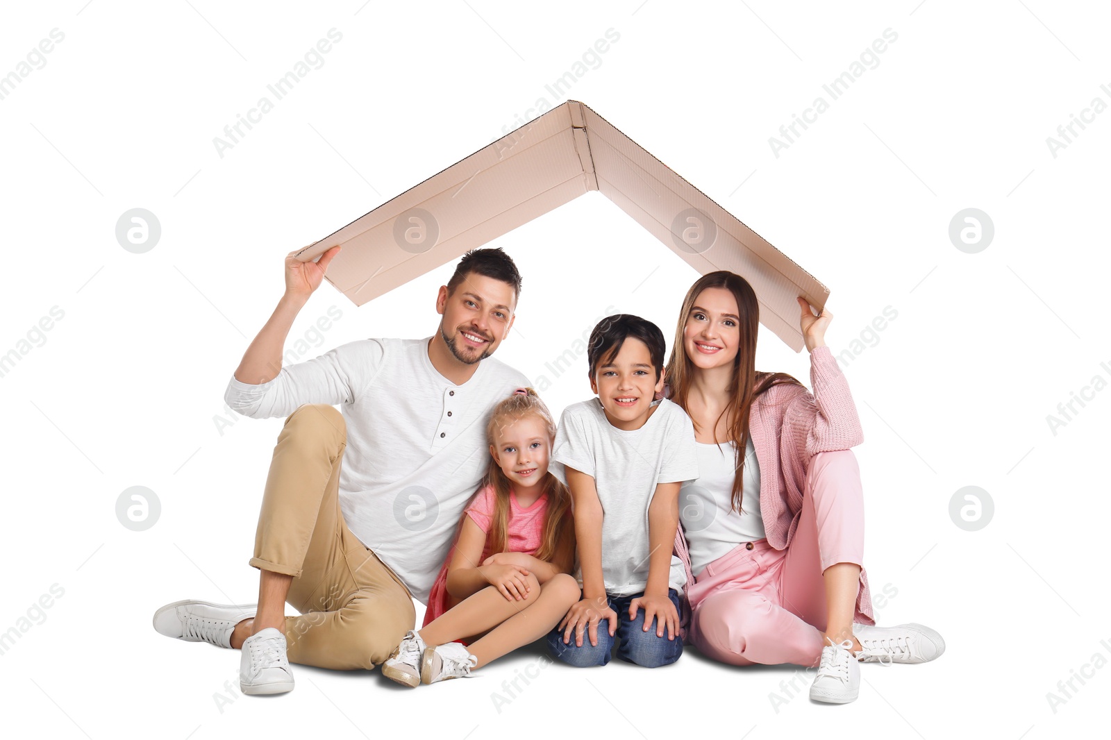 Photo of Happy family sitting under cardboard roof on white background. Insurance concept