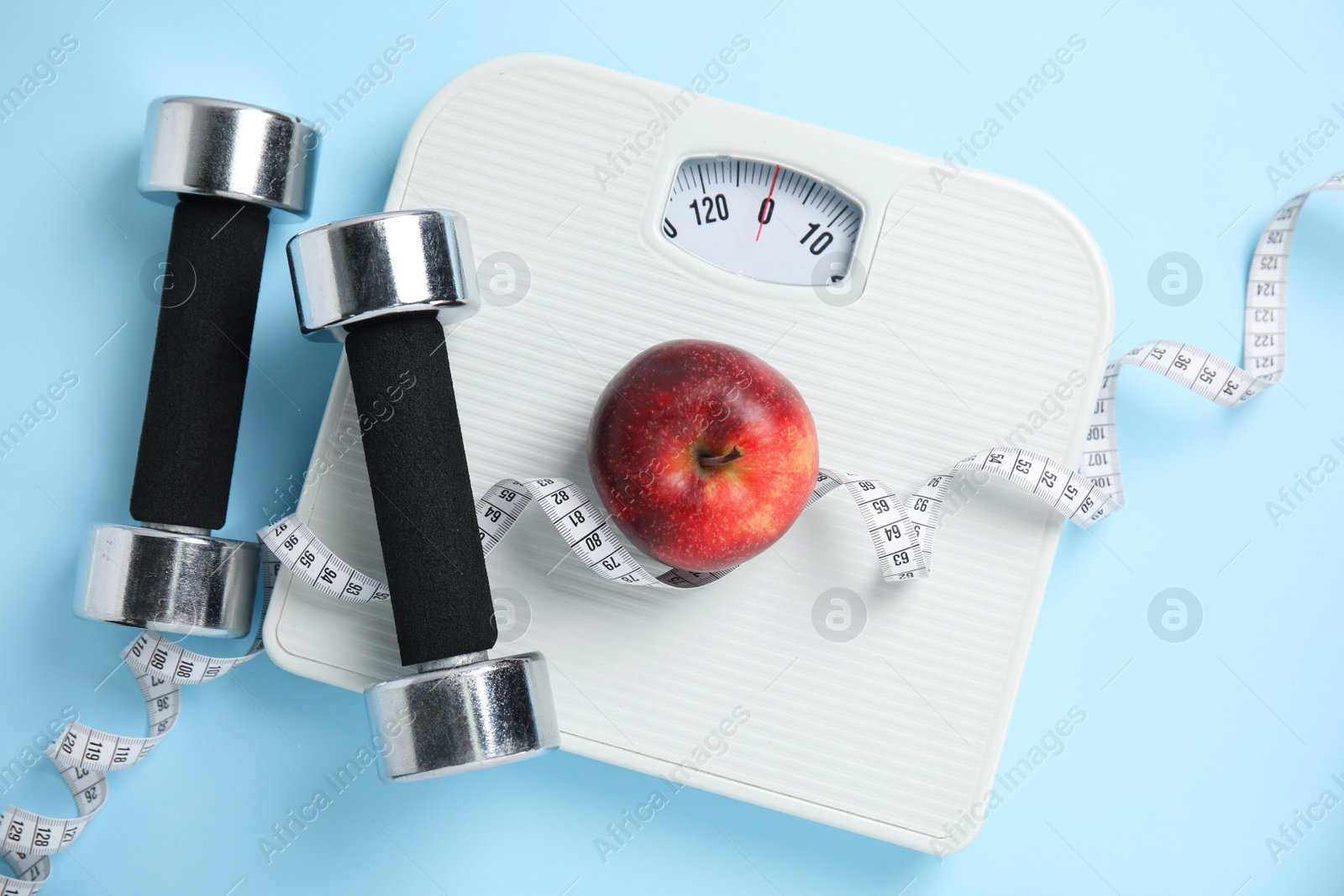 Flat lay composition with scales on light blue background Photo of Flat lay composition with scales on light blue background