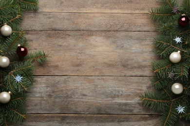 Photo of Flat lay composition with Christmas decorations on wooden background, space for text. Winter season