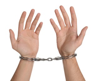 Photo of Freedom concept. Man with handcuffs on his hands against white background, closeup