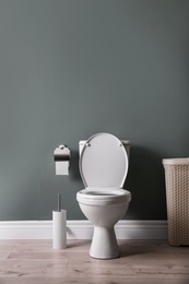 Photo of New ceramic toilet bowl in modern bathroom