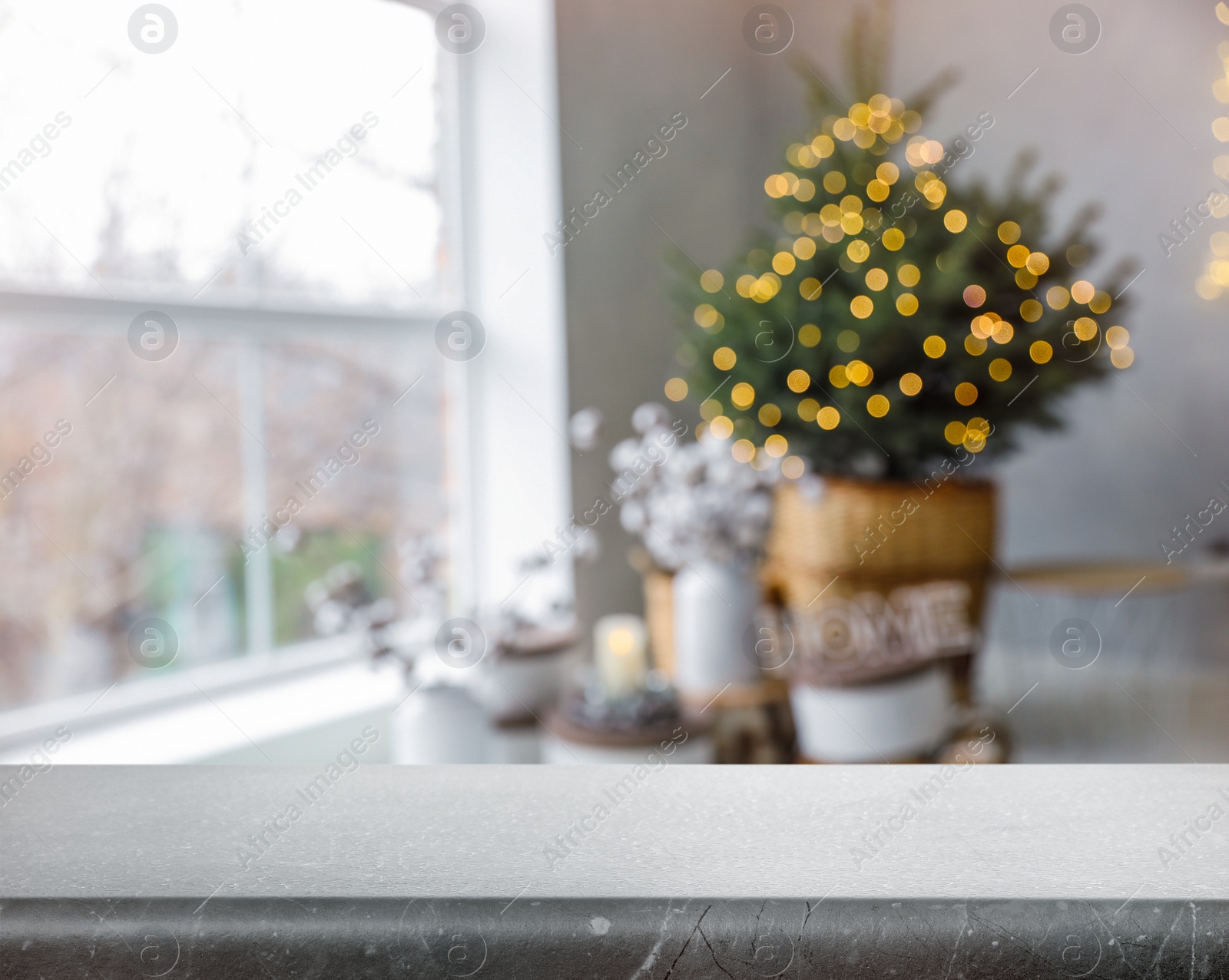 Image of Empty stone surface and blurred view of room decorated for Christmas