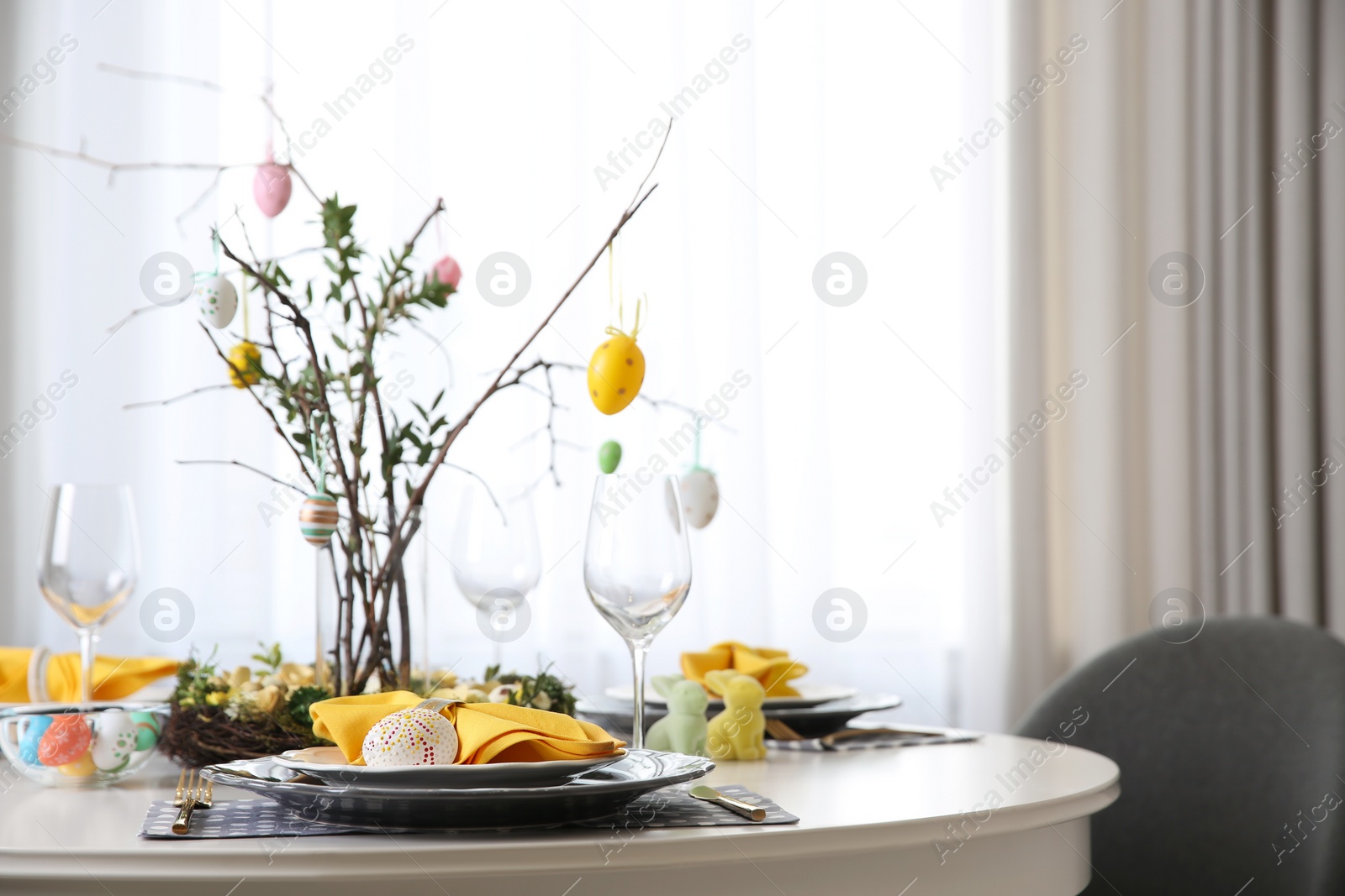 Photo of Beautiful Easter table setting with floral decor indoors