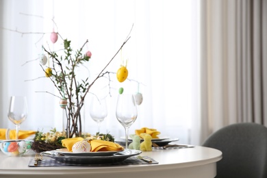 Beautiful Easter table setting with floral decor indoors