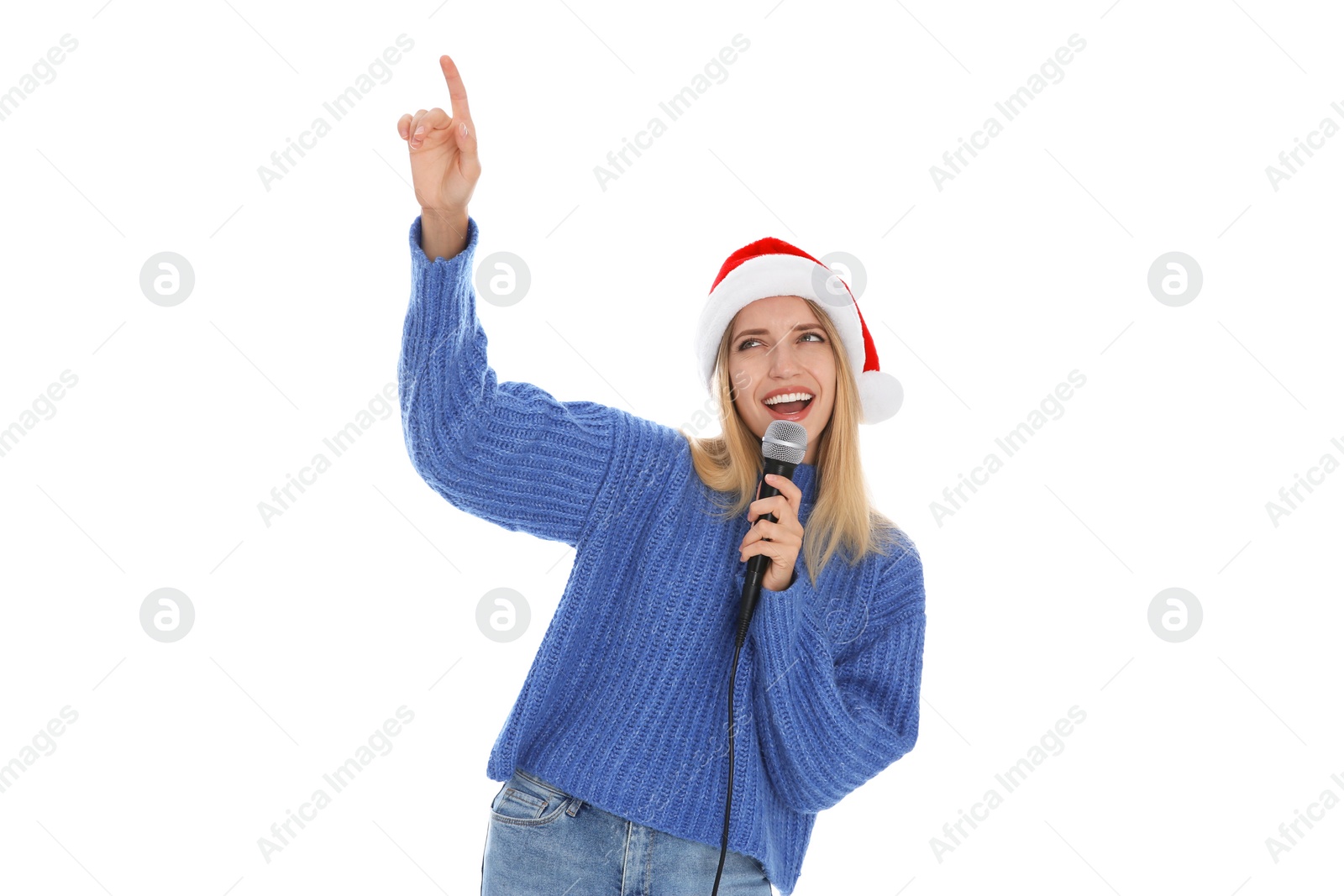 Photo of Happy woman in Santa Claus hat singing with microphone on white background. Christmas music