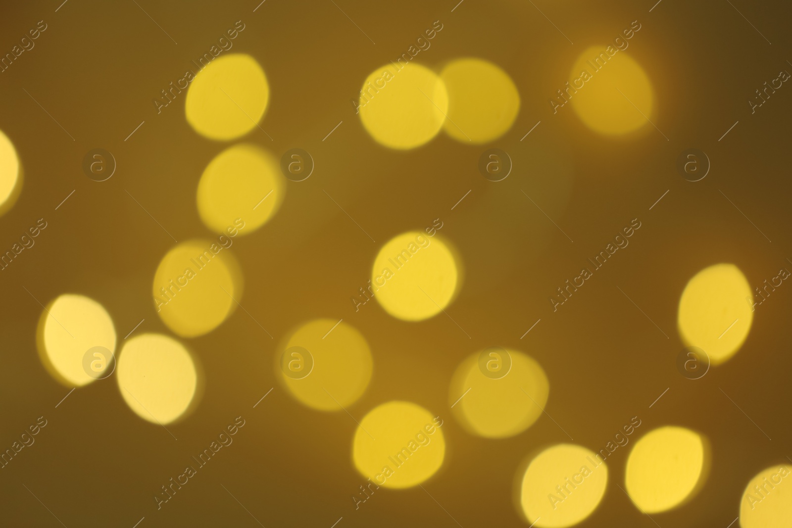 Photo of Blurred view of beautiful lights on color background