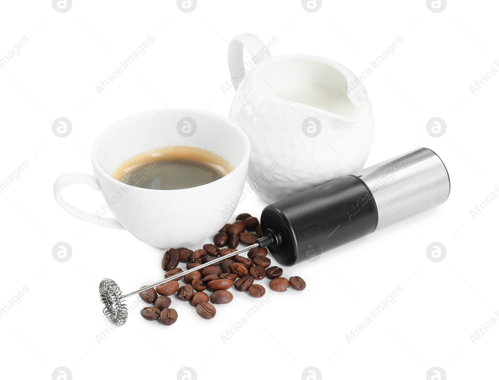 Photo of Mini mixer (milk frother), cup, coffee beans and pitcher isolated on white