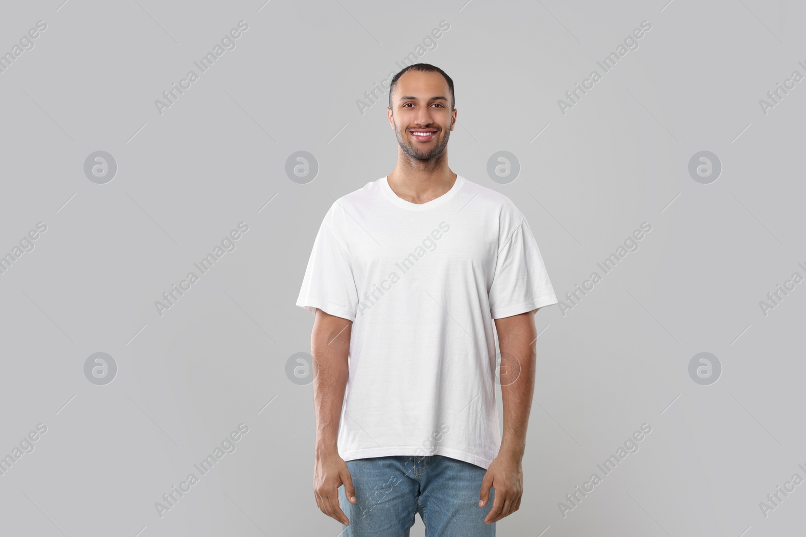 Photo of Man wearing white t-shirt on gray background