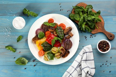Photo of Delicious grilled vegetables served on light blue wooden table, flat lay