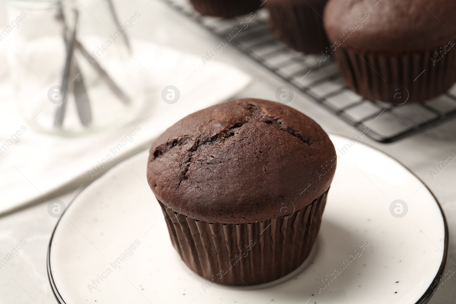 Photo of Delicious fresh chocolate cupcake on table, closeup