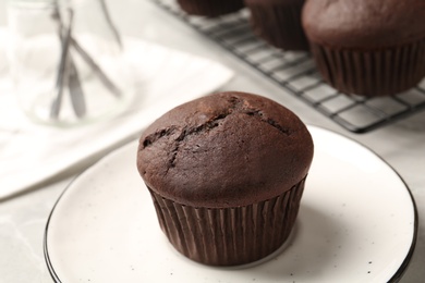 Delicious fresh chocolate cupcake on table, closeup