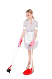 Young chambermaid with broom and dustpan on white background