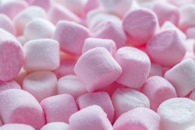 Photo of Delicious puffy pink and white marshmallows as background, closeup