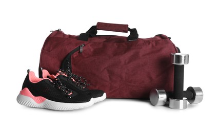 Sports bag and gym equipment on white background