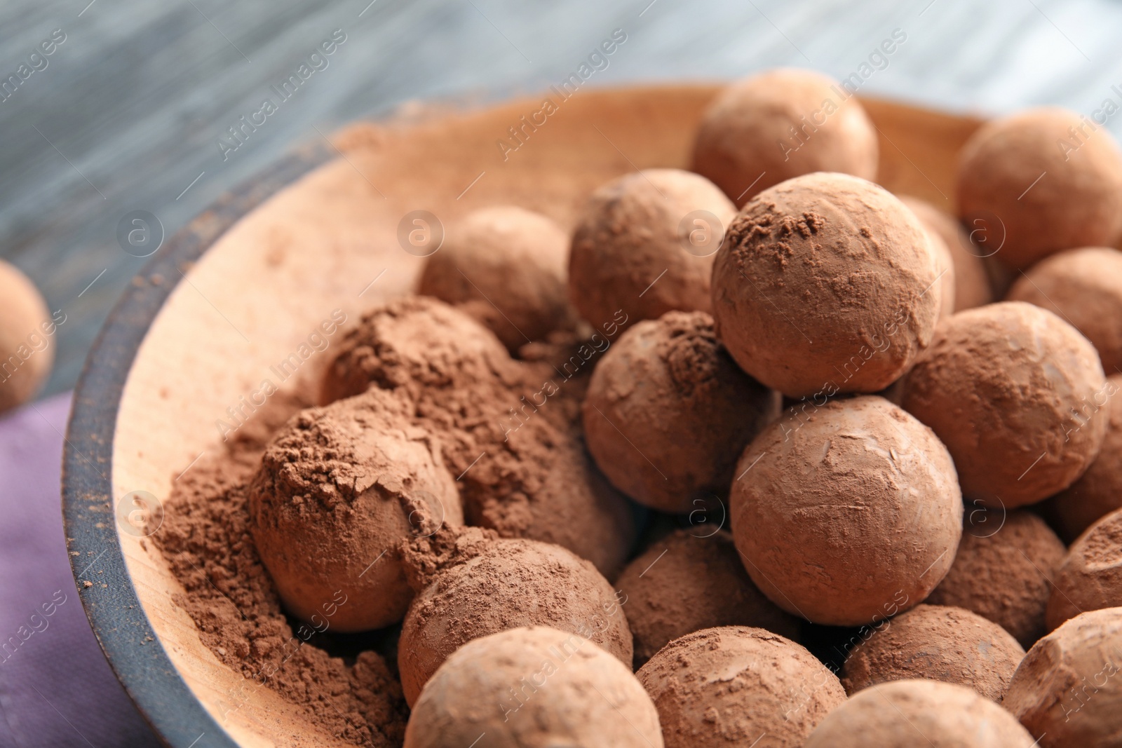 Photo of Plate with chocolate truffles on table, closeup