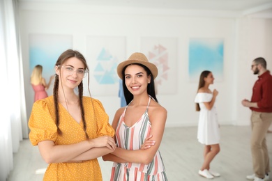 Photo of Young women at exhibition in art gallery