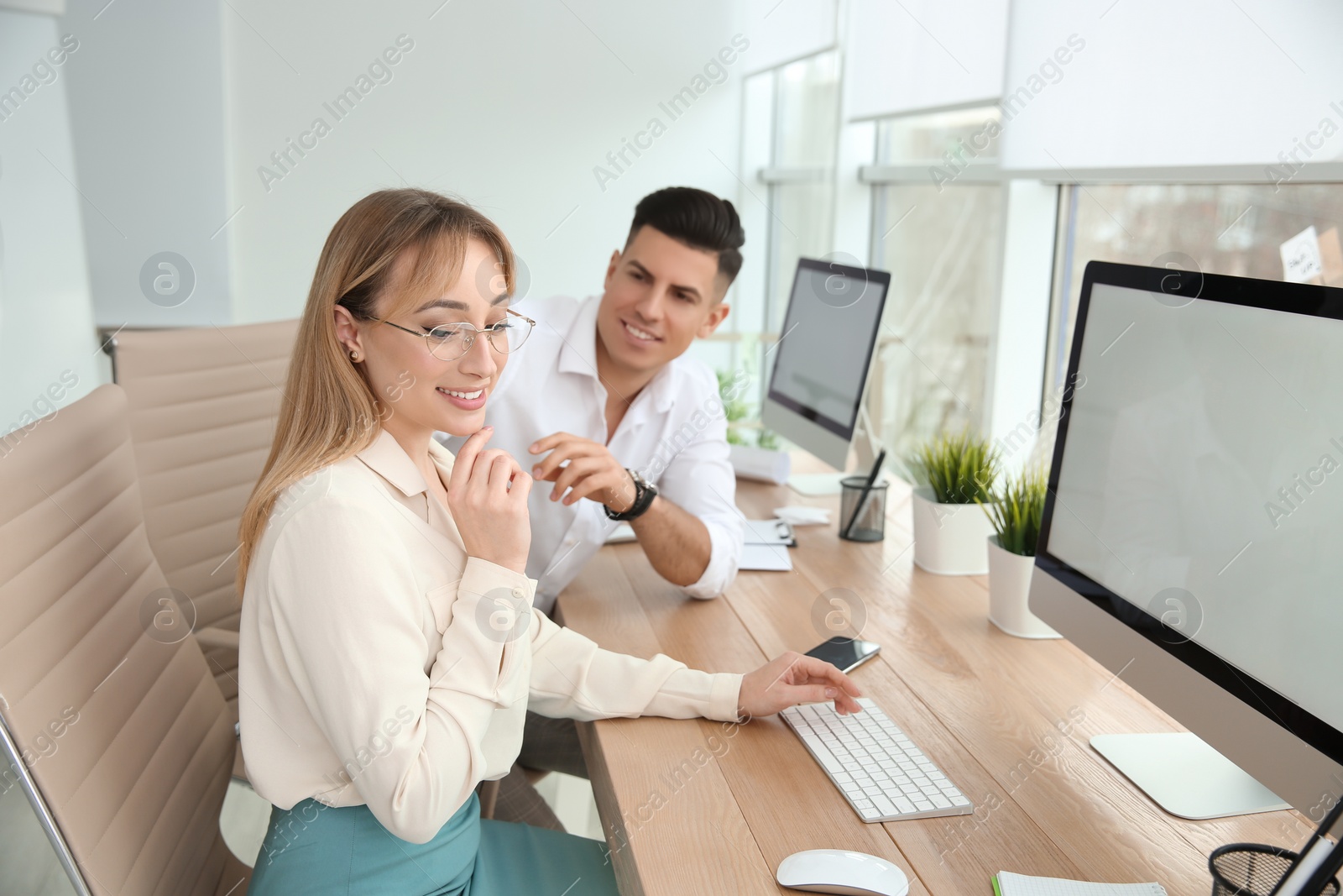 Photo of Man flirting with his colleague during work in office