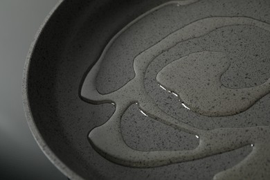 Photo of Cooking oil in frying pan, closeup view