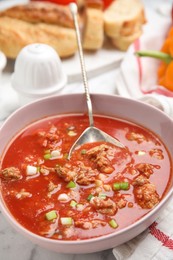 Photo of Bowl of delicious stuffed pepper soup on table