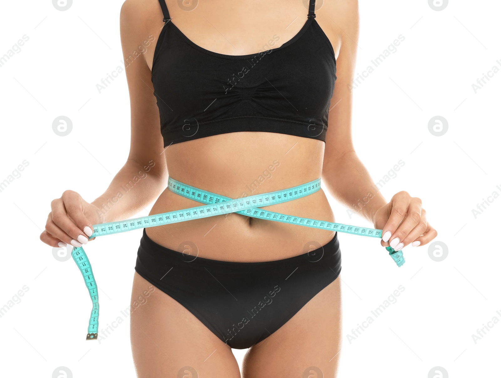 Photo of Slim young woman measuring her body with tape on white background, closeup