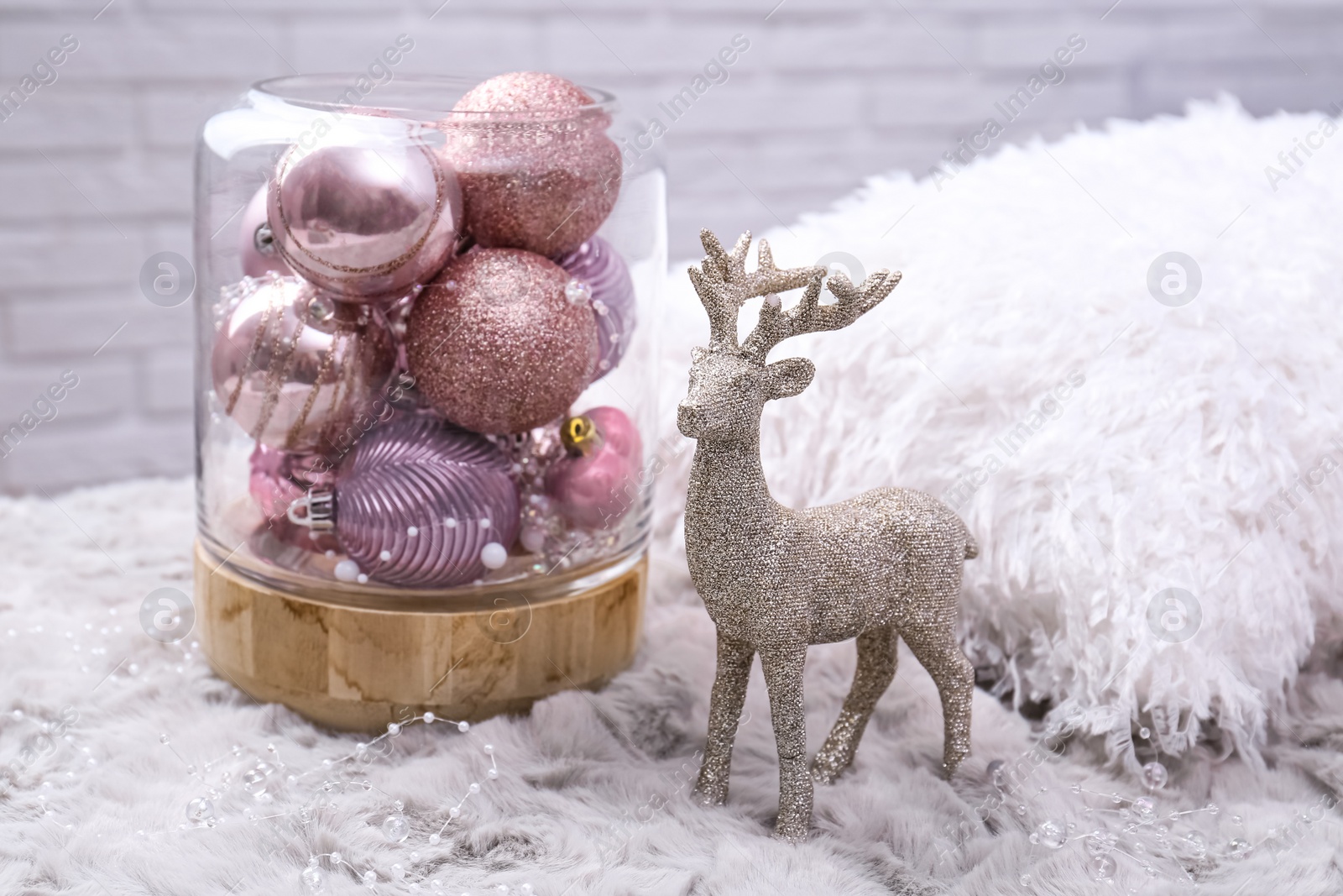 Photo of Beautiful pink Christmas baubles and deer on grey fur