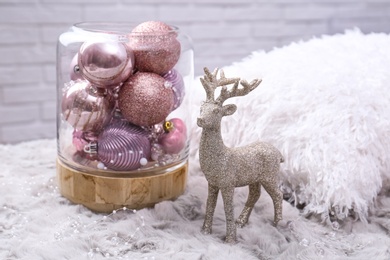 Beautiful pink Christmas baubles and deer on grey fur