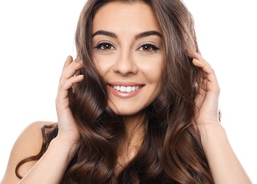 Beautiful woman with shiny wavy hair on white background