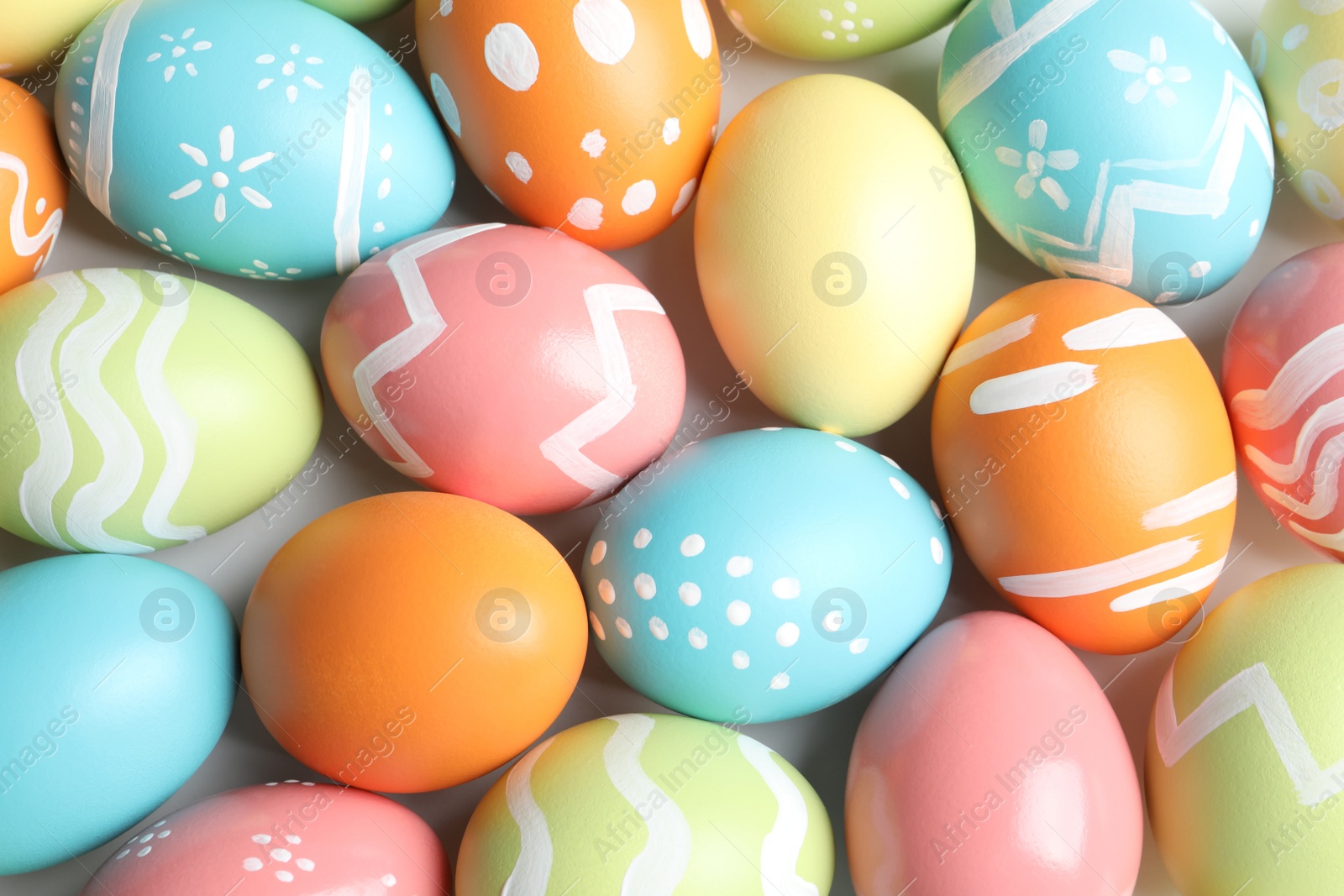 Photo of Many beautiful painted Easter eggs as background, top view