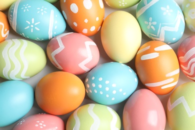 Photo of Many beautiful painted Easter eggs as background, top view