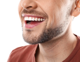 Smiling man with perfect teeth on white background, closeup