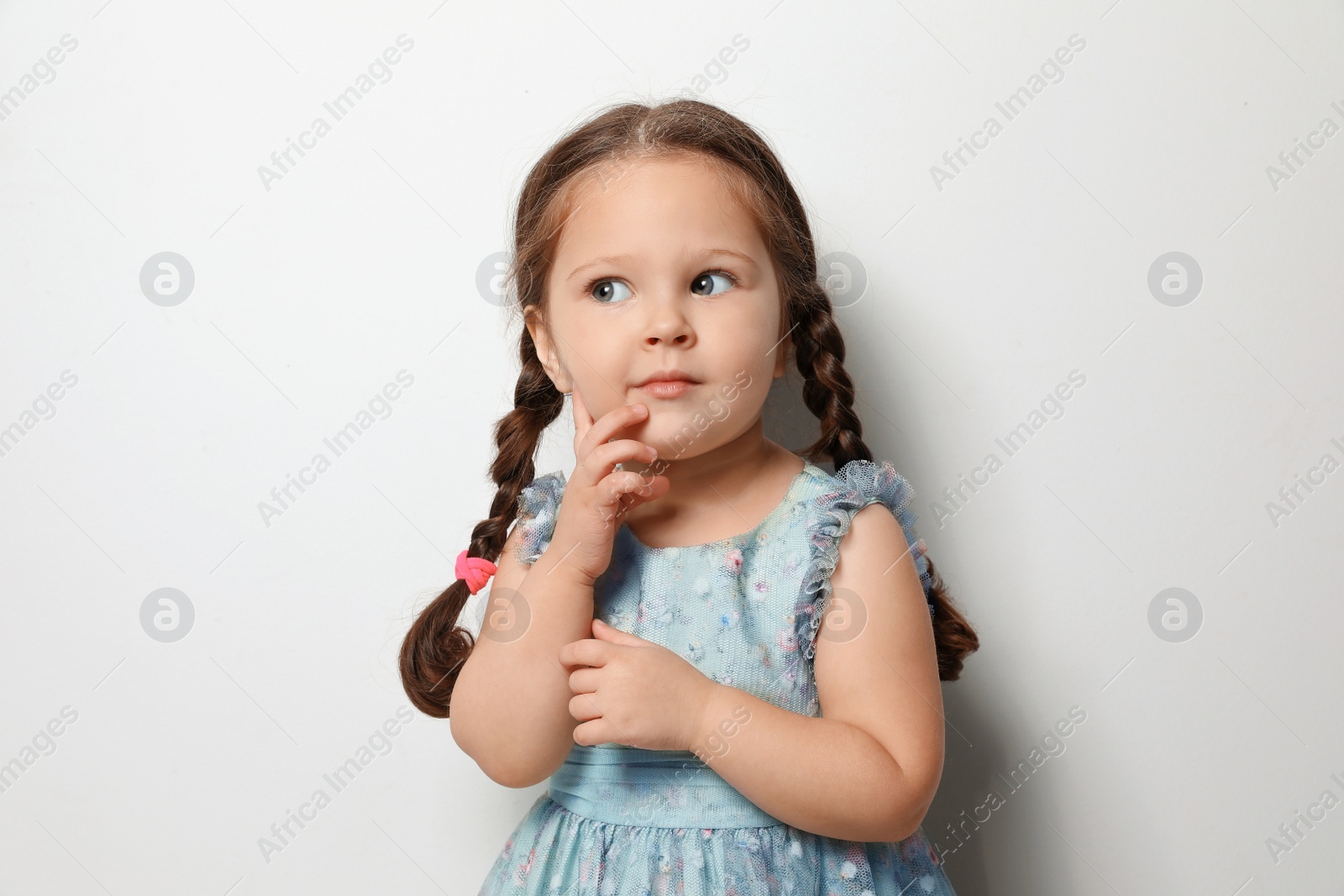 Photo of Cute little girl on light grey background