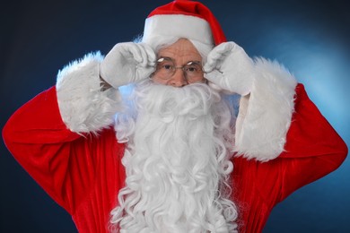 Photo of Man in Santa Claus costume on color background
