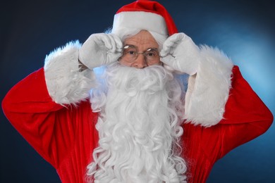 Man in Santa Claus costume on color background