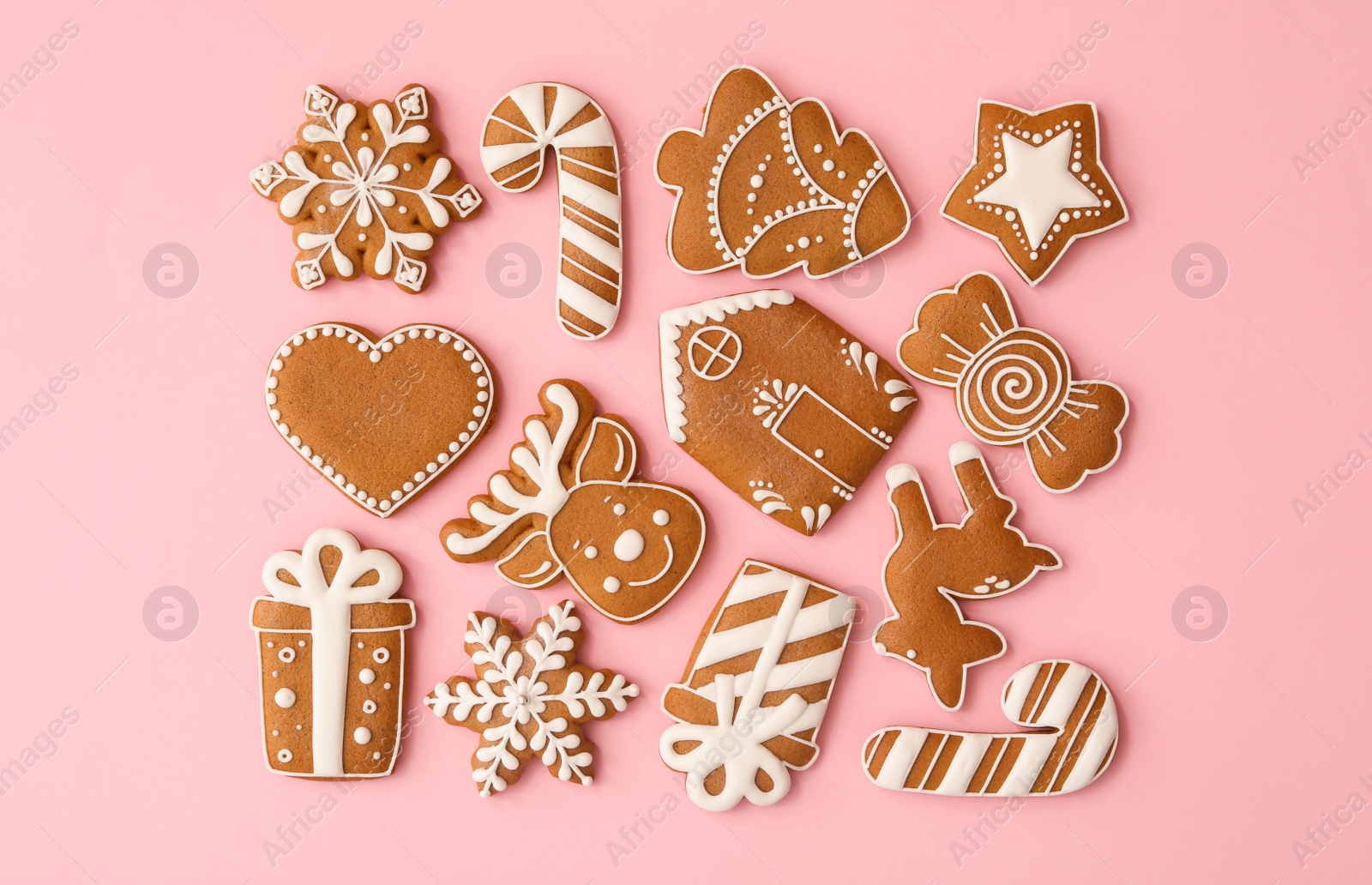 Photo of Different Christmas gingerbread cookies on pink background, flat lay