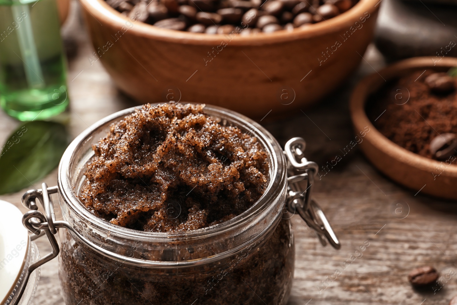 Photo of Jar with handmade natural body scrub on table, closeup