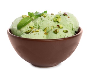 Photo of Bowl of sweet pistachio ice cream with mint on white background