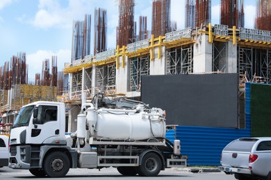 Photo of Modern truck with concrete pump near construction site