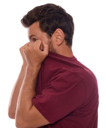 Man covering face with shirt on white background